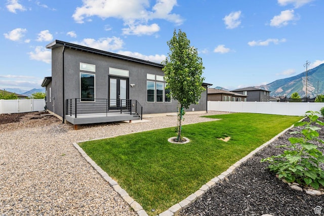 2628 E 40 N Unit 9, Spanish Fork, UT 84660 - back of house featuring a fenced backyard, french doors, a deck with mountain view, and stucco siding