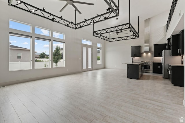 2628 E 40 N Unit 9, Spanish Fork, UT 84660 - kitchen featuring dark cabinets, open floor plan, stainless steel stove, a towering ceiling, and ceiling fan