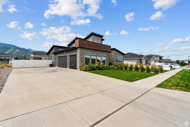 2628 E 40 N Unit 9, Spanish Fork, UT 84660 - view of front facade featuring a garage, a gate, driveway, stone siding, and a mountain view
