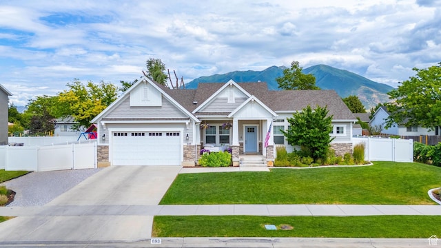 693 S 860 E, Spanish Fork, UT 84660 - craftsman inspired home with concrete driveway, a mountain view, stone siding, a porch, and an attached garage