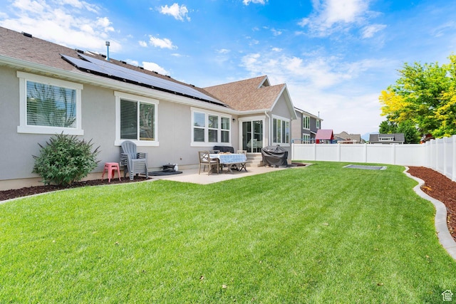 693 S 860 E, Spanish Fork, UT 84660 - back of property with roof mounted solar panels, a patio, a fenced backyard, stucco siding, and a shingled roof