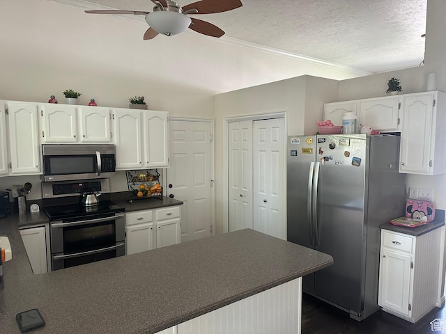 1145 N 560 W, Orem, UT 84057 - kitchen with stainless steel appliances, dark countertops, a ceiling fan, white cabinetry, and a textured ceiling
