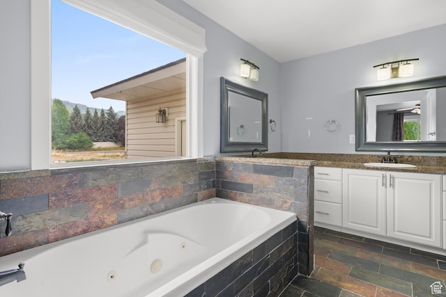 325 W Burgi Ln, Midway, UT 84049 - bathroom featuring a jetted tub, vanity, stone finish floors, and a mountain view