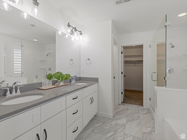 1907 E Brooklyn Cir N, Saratoga Springs, UT 84045 - bathroom with a stall shower, marble finish floors, double vanity, a walk in closet, and recessed lighting