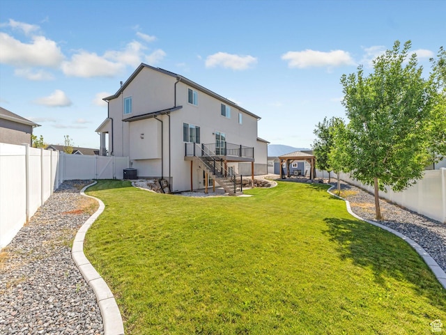 1907 E Brooklyn Cir N, Saratoga Springs, UT 84045 - back of property featuring a gazebo, a fenced backyard, stairway, stucco siding, and a deck