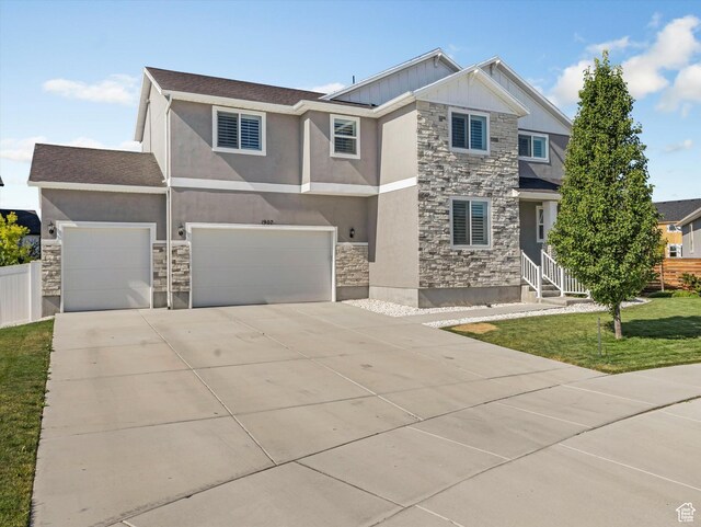 1907 E Brooklyn Cir N, Saratoga Springs, UT 84045 - view of front facade featuring stone siding, driveway, and stucco siding