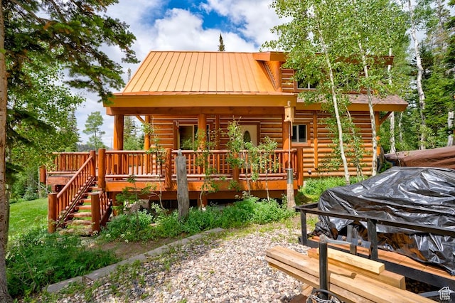 556 N Half Circle Dr, Brian Head, UT 84719 - back of house with a metal roof, log siding, a deck, and a standing seam roof