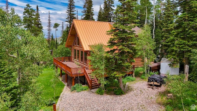 556 N Half Circle Dr, Brian Head, UT 84719 - rear view of property with log exterior, a wooden deck, stairs, a metal roof, and a standing seam roof