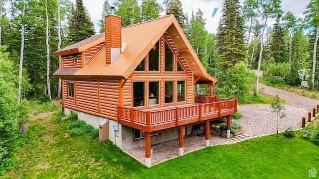 556 N Half Circle Dr, Brian Head, UT 84719 - back of house with a wooden deck, a yard, a chimney, and a metal roof