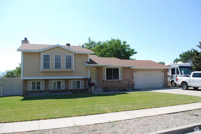 10642 S 1090 E, Sandy, UT 84094 - tri-level home with brick siding, a garage, concrete driveway, and a shingled roof