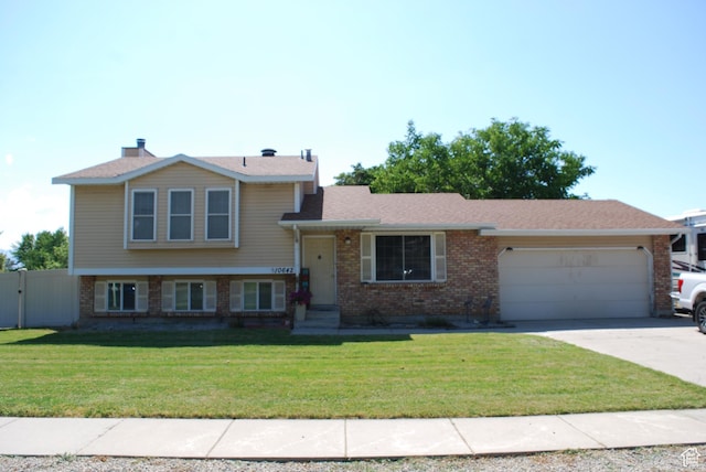 10642 S 1090 E, Sandy, UT 84094 - tri-level home with brick siding, a garage, and driveway