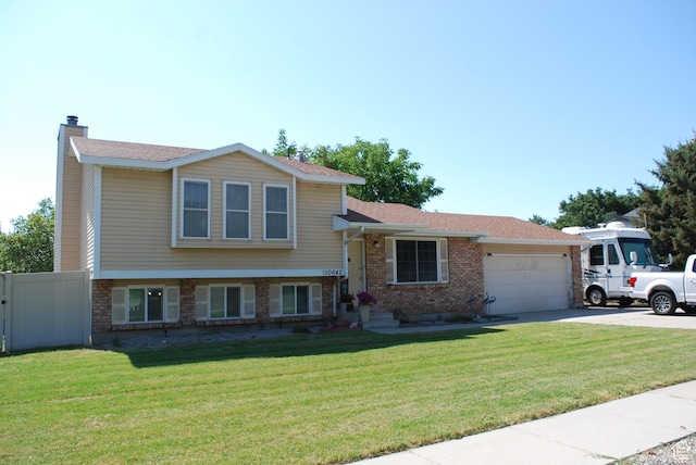 10642 S 1090 E, Sandy, UT 84094 - split level home with brick siding, a garage, concrete driveway, and a chimney