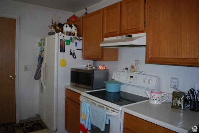 10642 S 1090 E, Sandy, UT 84094 - kitchen featuring white electric stove, under cabinet range hood, stainless steel microwave, brown cabinetry, and light countertops