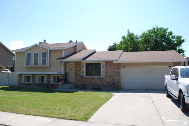 10642 S 1090 E, Sandy, UT 84094 - split level home featuring brick siding, an attached garage, and driveway