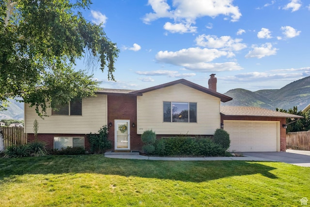 694 E 2350 N, North Ogden, UT 84414 - view of front of home featuring brick siding, a garage, driveway, and a chimney