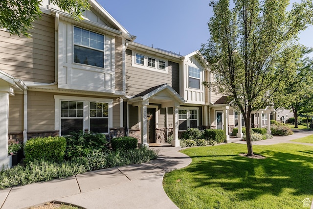 265 W 1010 S, Logan, UT 84321 - townhome / multi-family property with a front lawn and stone siding