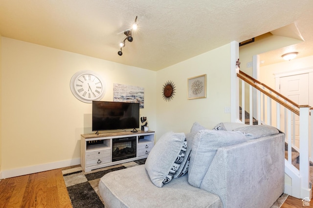 265 W 1010 S, Logan, UT 84321 - living room with wood finished floors, stairs, and a textured ceiling