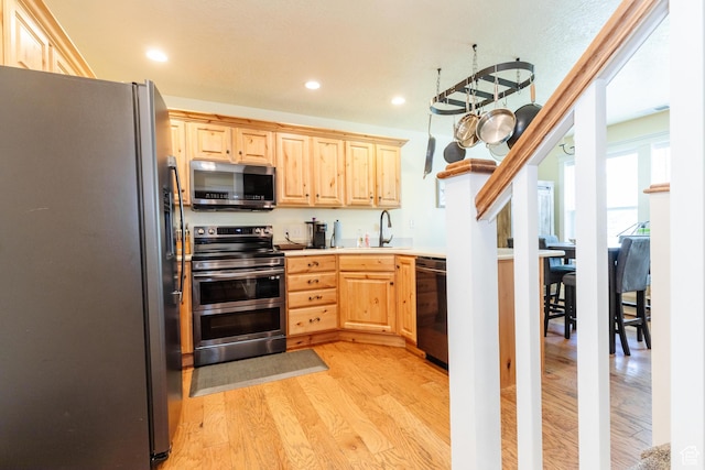 265 W 1010 S, Logan, UT 84321 - kitchen featuring appliances with stainless steel finishes, light brown cabinets, light wood-type flooring, light countertops, and recessed lighting
