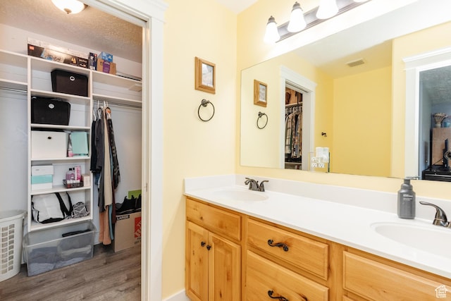 265 W 1010 S, Logan, UT 84321 - full bath with wood finished floors, double vanity, and a walk in closet