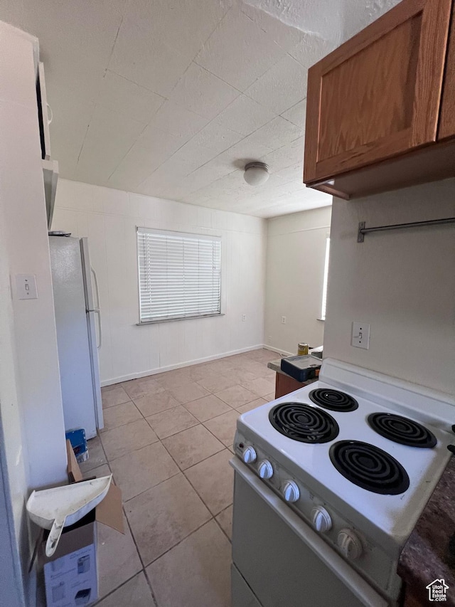 495 E Center St, Pleasant Grove, UT 84062 - kitchen with white appliances, light tile patterned floors, and brown cabinets