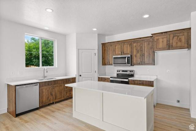 222 E 300 N, Payson, UT 84651 - kitchen featuring appliances with stainless steel finishes, light wood-style flooring, light countertops, a center island, and recessed lighting