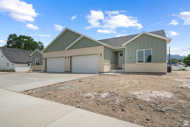 222 E 300 N, Payson, UT 84651 - view of front of home featuring board and batten siding, an attached garage, concrete driveway, and roof with shingles