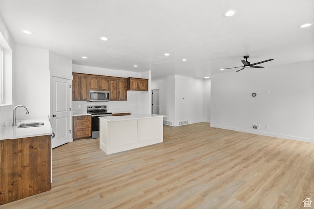 222 E 300 N, Payson, UT 84651 - kitchen featuring appliances with stainless steel finishes, recessed lighting, a kitchen island, light wood-type flooring, and ceiling fan