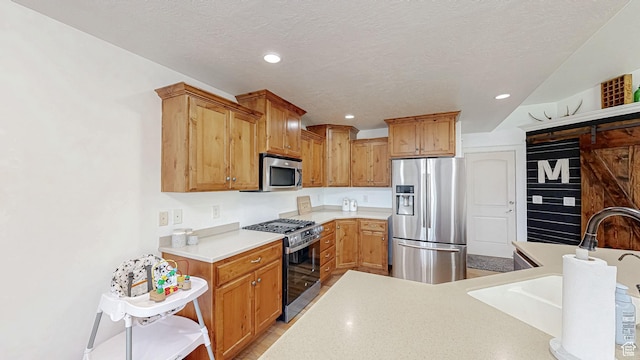 645 Stonebrook Ln, Santaquin, UT 84655 - kitchen featuring appliances with stainless steel finishes, light countertops, recessed lighting, and a textured ceiling