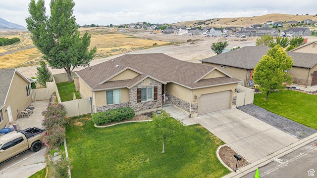 645 Stonebrook Ln, Santaquin, UT 84655 - view of front of house featuring stucco siding, stone siding, an attached garage, driveway, and a residential view