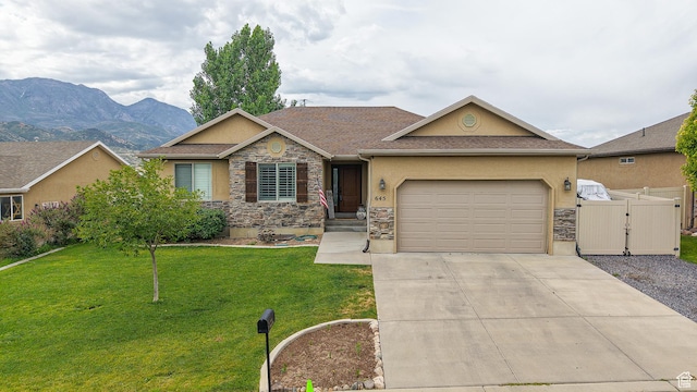 645 Stonebrook Ln, Santaquin, UT 84655 - view of front facade with a gate, stucco siding, stone siding, concrete driveway, and a garage