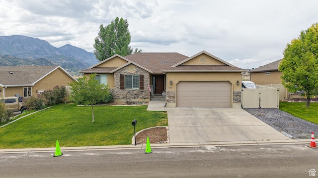 645 Stonebrook Ln, Santaquin, UT 84655 - view of front facade featuring stone siding, stucco siding, driveway, an attached garage, and a gate