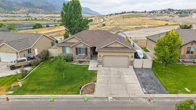 645 Stonebrook Ln, Santaquin, UT 84655 - view of front of home with stone siding, concrete driveway, stucco siding, a garage, and a gate