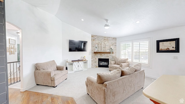645 Stonebrook Ln, Santaquin, UT 84655 - living room with vaulted ceiling, arched walkways, a fireplace, light wood finished floors, and recessed lighting