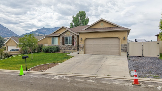 645 Stonebrook Ln, Santaquin, UT 84655 - view of front of home with stone siding, a gate, concrete driveway, and stucco siding