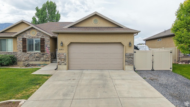 645 Stonebrook Ln, Santaquin, UT 84655 - view of front of home featuring stone siding, a gate, stucco siding, and driveway