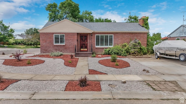 361 E Mcmillan Ln, Murray, UT 84107 - view of front facade featuring brick siding, a chimney, and roof with shingles