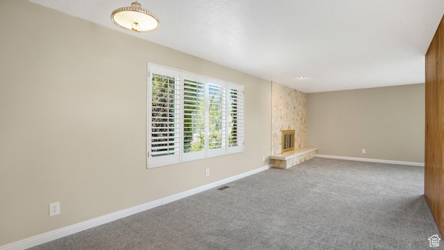 361 E Mcmillan Ln, Murray, UT 84107 - unfurnished living room with carpet flooring and a stone fireplace