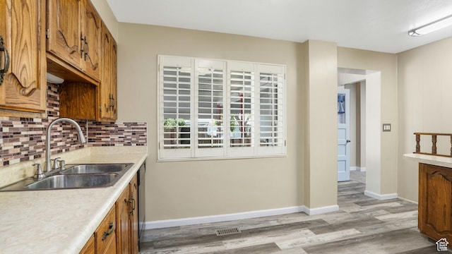 361 E Mcmillan Ln, Murray, UT 84107 - kitchen featuring brown cabinets, light wood-style floors, and light countertops