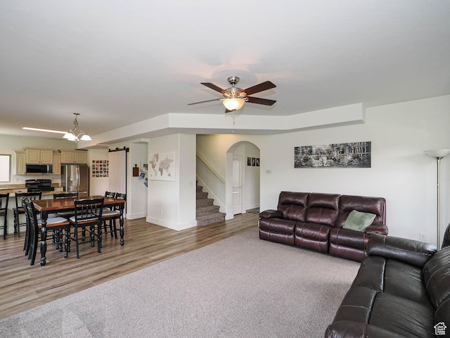 373 N Willow Haven Ave, Lehi, UT 84043 - living area with arched walkways, light wood-type flooring, ceiling fan, and stairs