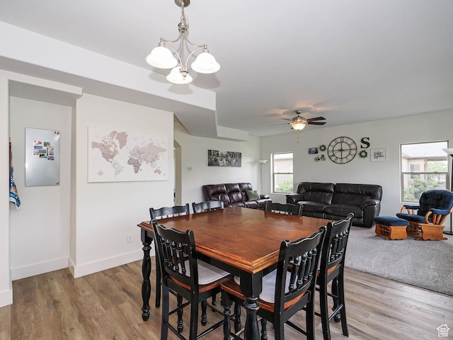 373 N Willow Haven Ave, Lehi, UT 84043 - dining room with healthy amount of natural light, a ceiling fan, light wood-style flooring, and a chandelier