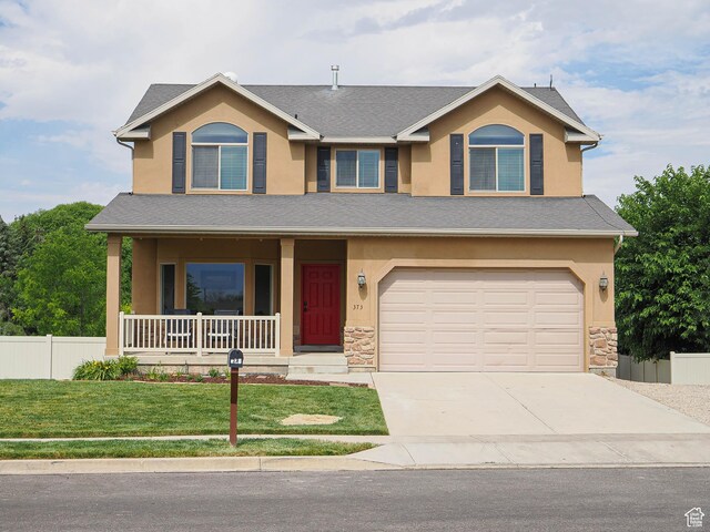 373 N Willow Haven Ave, Lehi, UT 84043 - view of front facade featuring a porch, stone siding, stucco siding, driveway, and an attached garage