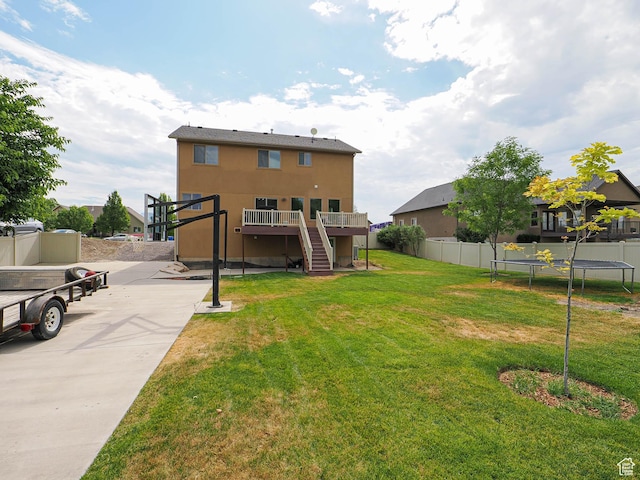 373 N Willow Haven Ave, Lehi, UT 84043 - back of house with a trampoline, stairs, a deck, and stucco siding