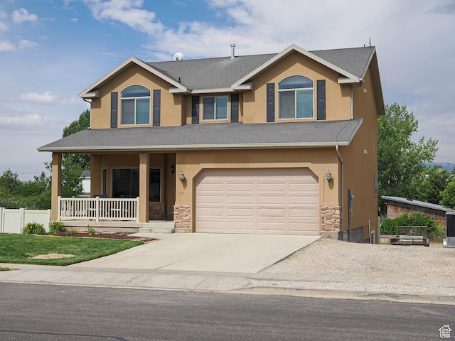 373 N Willow Haven Ave, Lehi, UT 84043 - view of front facade with covered porch, stone siding, concrete driveway, and an attached garage