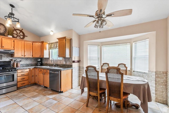 6956 S Firefox Cir, West Jordan, UT 84084 - kitchen with stainless steel appliances, range hood, dark countertops, vaulted ceiling, and a ceiling fan