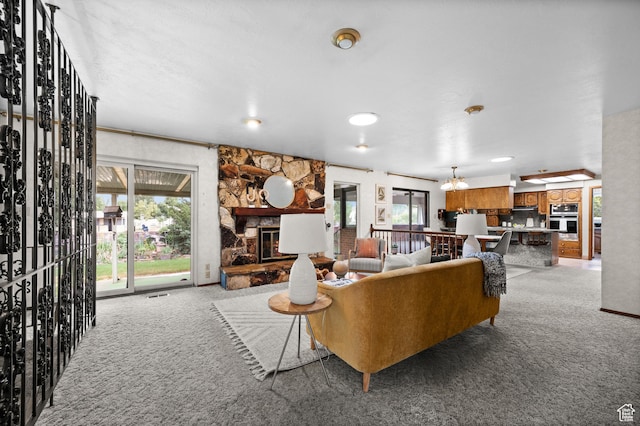 1575 W Alley St, Riverton, UT 84065 - living room featuring light carpet, a fireplace, and a chandelier