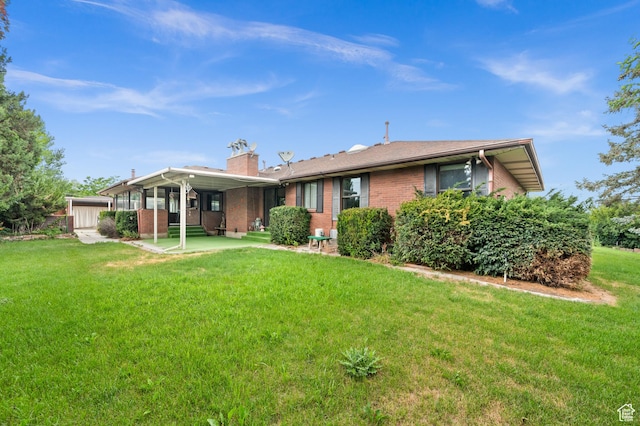 1575 W Alley St, Riverton, UT 84065 - rear view of property featuring brick siding, a yard, and a chimney