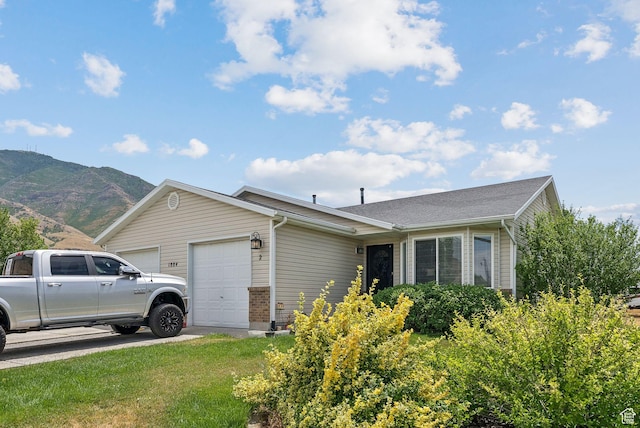 1884 E Shepard Ln, Lake Point, UT 84074 - view of front of house with a garage and a mountain view