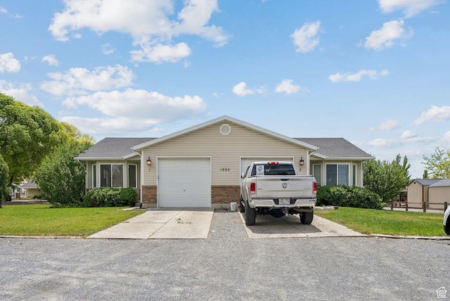 1884 E Shepard Ln, Lake Point, UT 84074 - single story home with an attached garage, a front yard, driveway, and brick siding