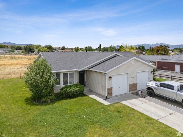 1884 E Shepard Ln, Lake Point, UT 84074 - ranch-style house featuring a garage, a front lawn, concrete driveway, a shingled roof, and a mountain view