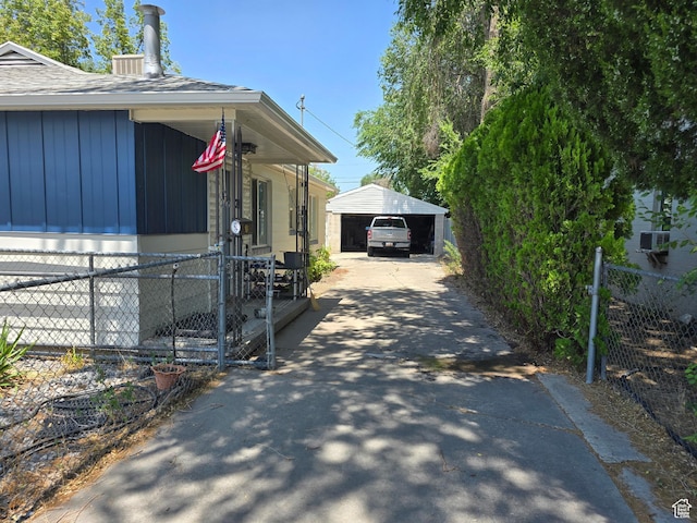 1134 W Illinois Ave S, Salt Lake City, UT 84104 - view of side of property featuring a carport, asphalt driveway, and board and batten siding